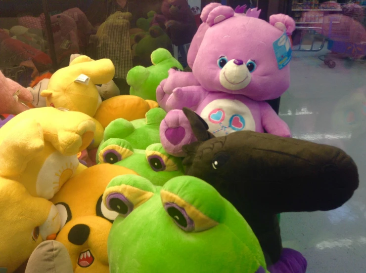 a group of different colored stuffed animals that are being displayed