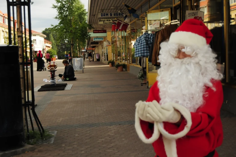 a man dressed in red and white holding a bag