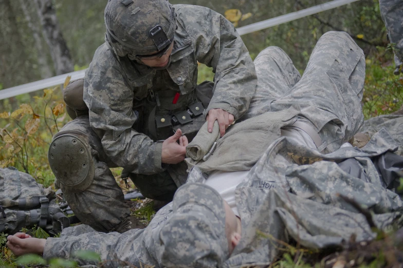 some men in uniform sitting on the ground