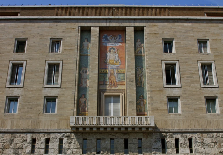 a painting on the side of a building with windows on each floor