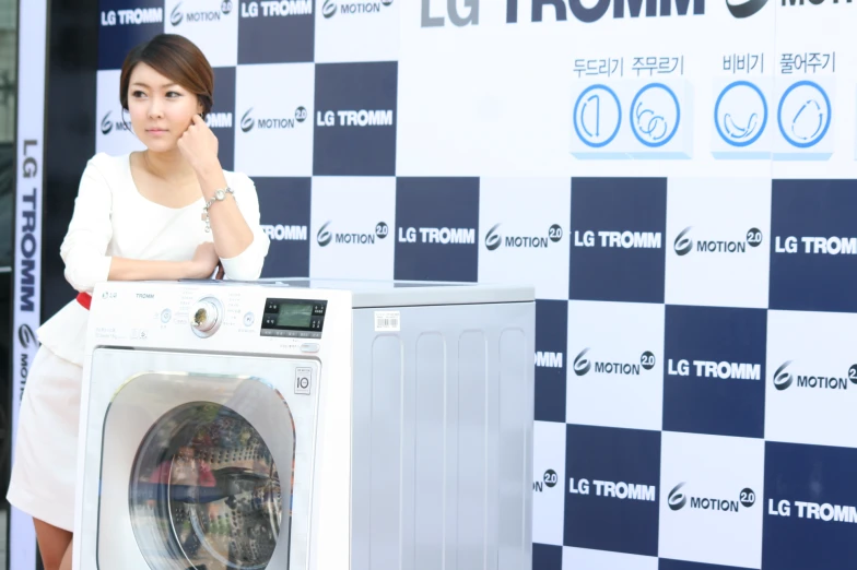 asian woman standing next to washing machine and checkered background