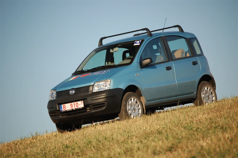 an suv sits on top of a hill