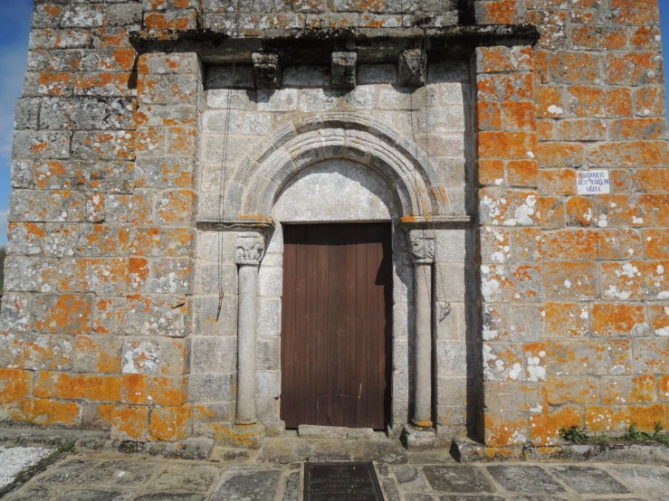 a close up of the front door to an old, rustic stone building