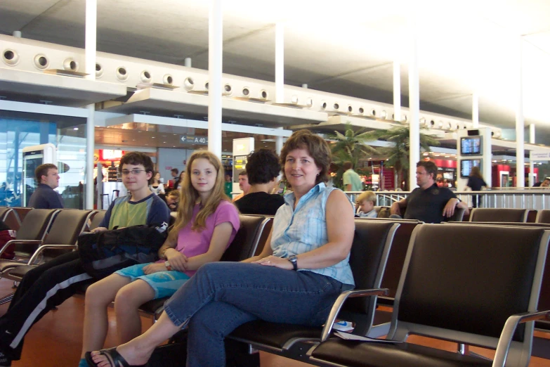 a group of people sitting on seats next to each other