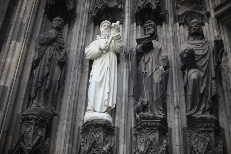 an ornately carved and decorated statue next to a giant building