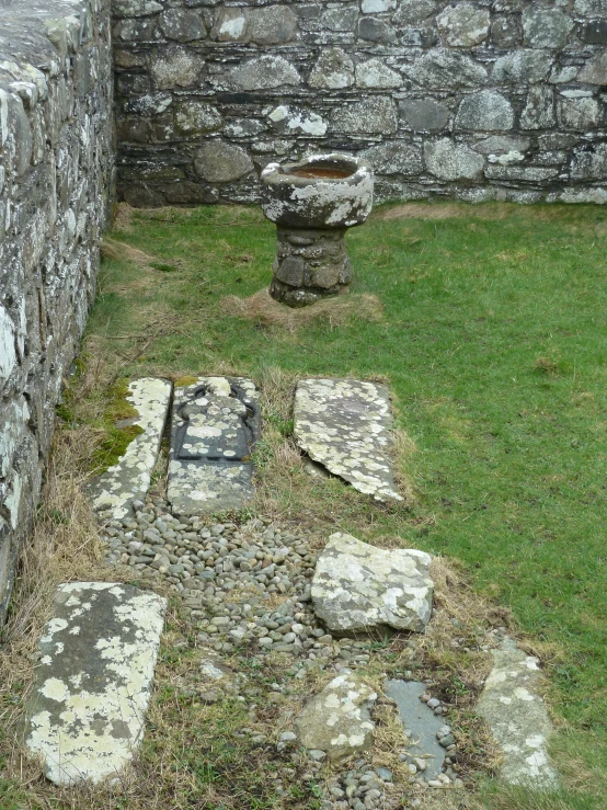 a stone area with several stepping steps and small stone pedestal