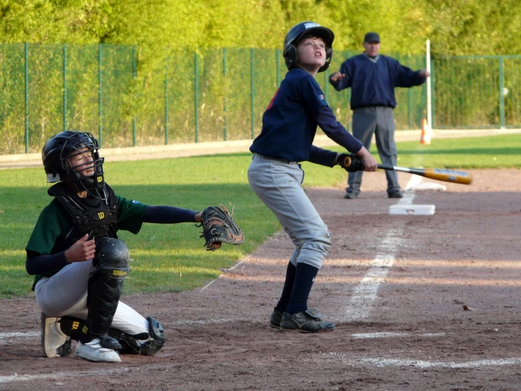 three s play a game of baseball on a field