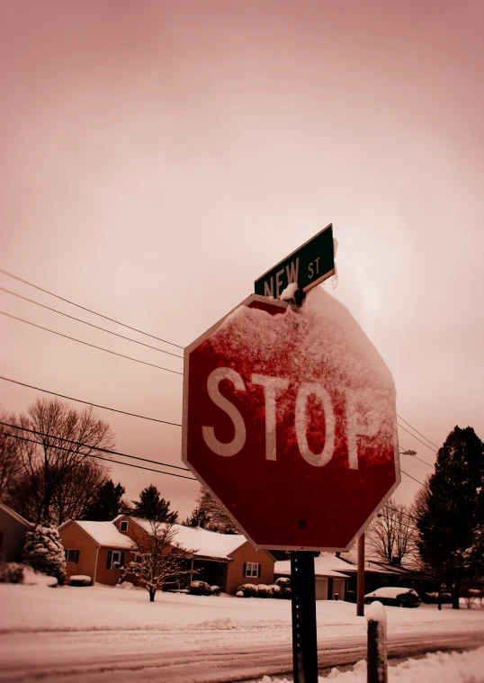 a stop sign on a snowy street corner