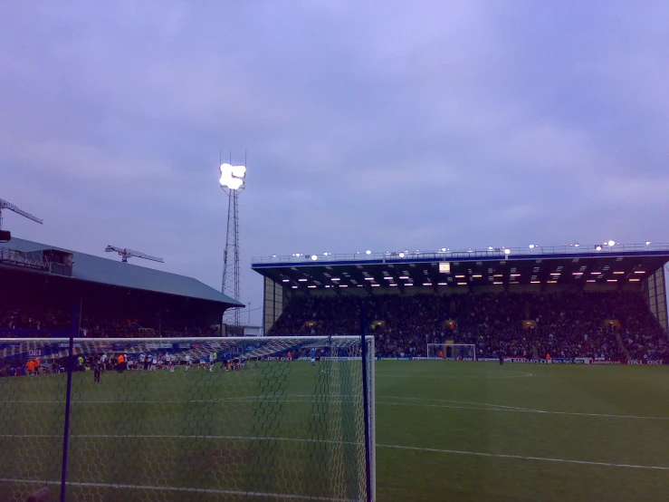 soccer field with lots of people and blue sky