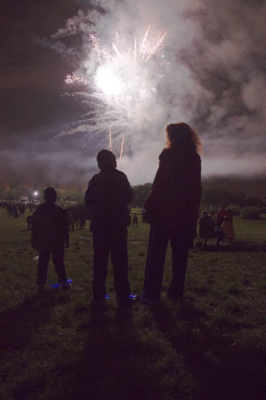 two people watching a fireworks display at night