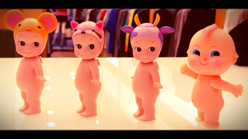 a toy set of four baby dolls wearing devil heads