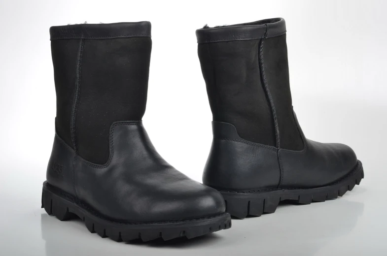 pair of boots on white surface with white background