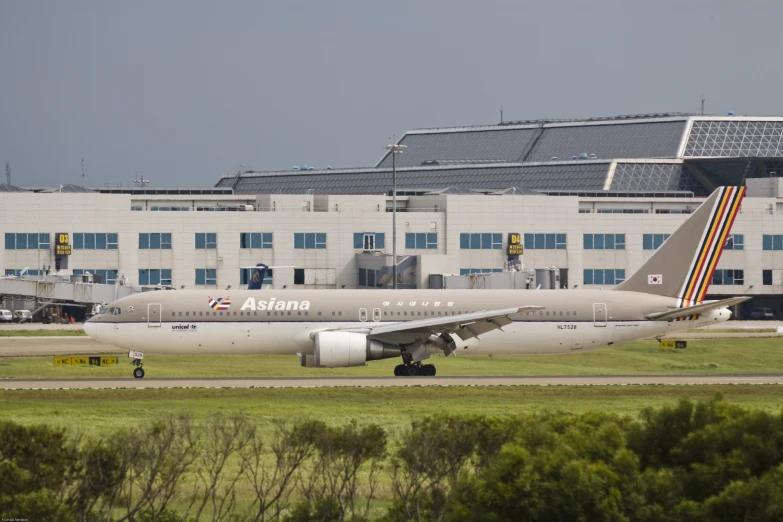 a delta airplane on a runway near some buildings