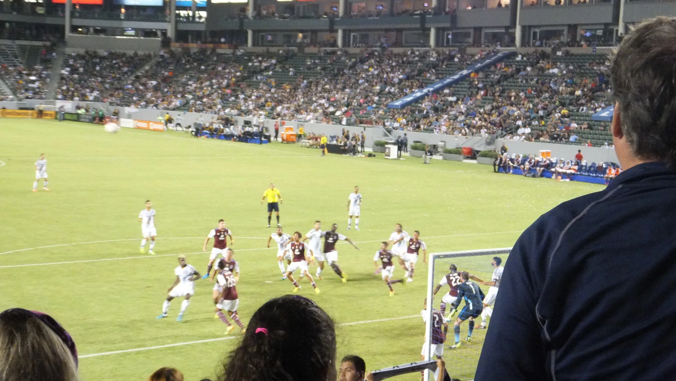 people are watching a soccer game in a stadium