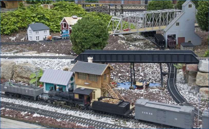 a model house and railroad cars are in a train yard