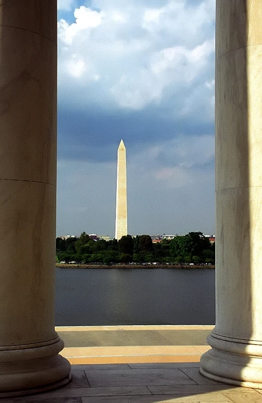 columns and a clock tower in the background overlooking the water