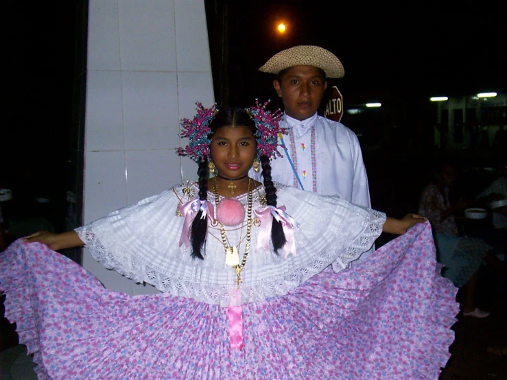 a couple pose together while wearing costume at night