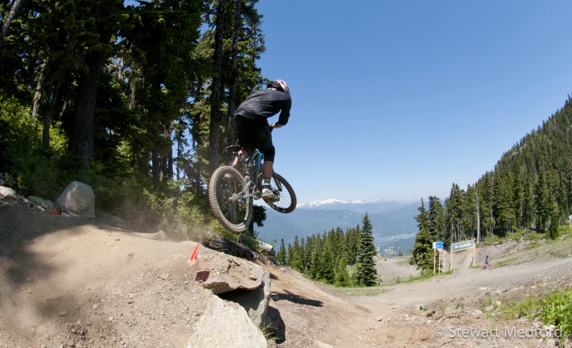 a downhill bike rider is riding a steep dirt hill