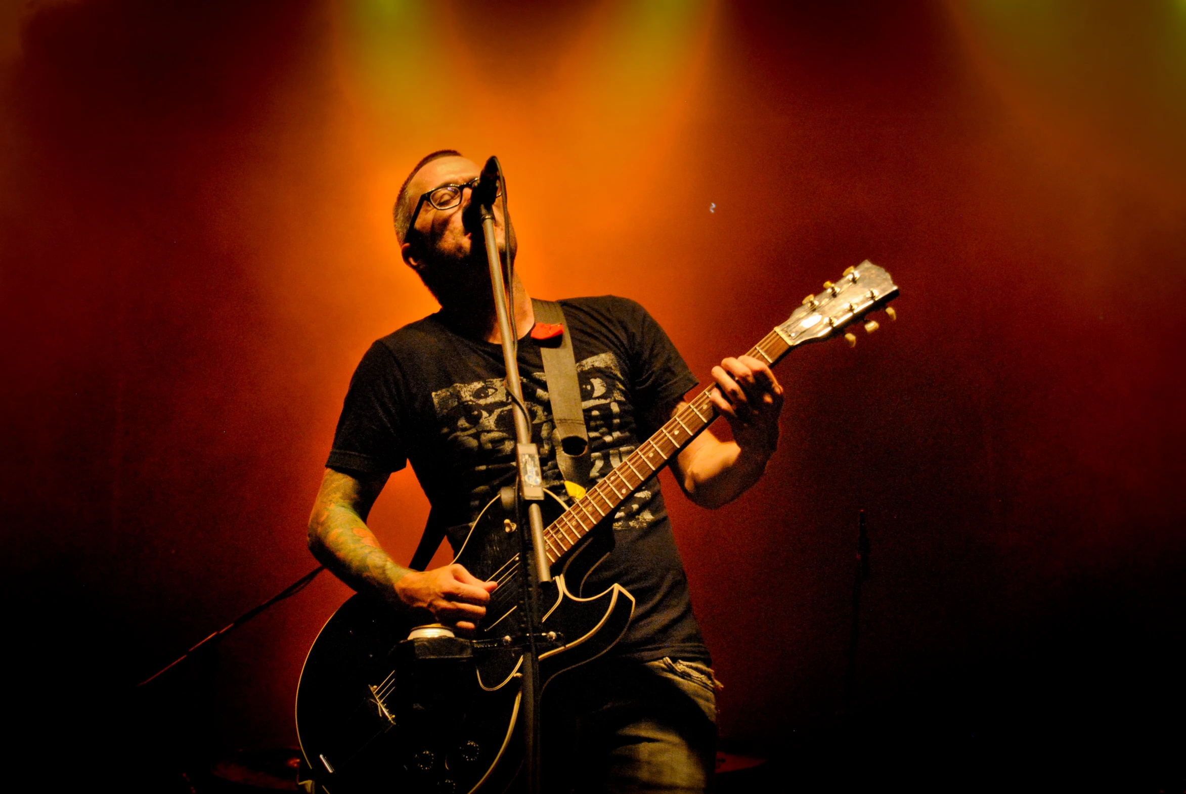 a man is holding an electric guitar in his hands