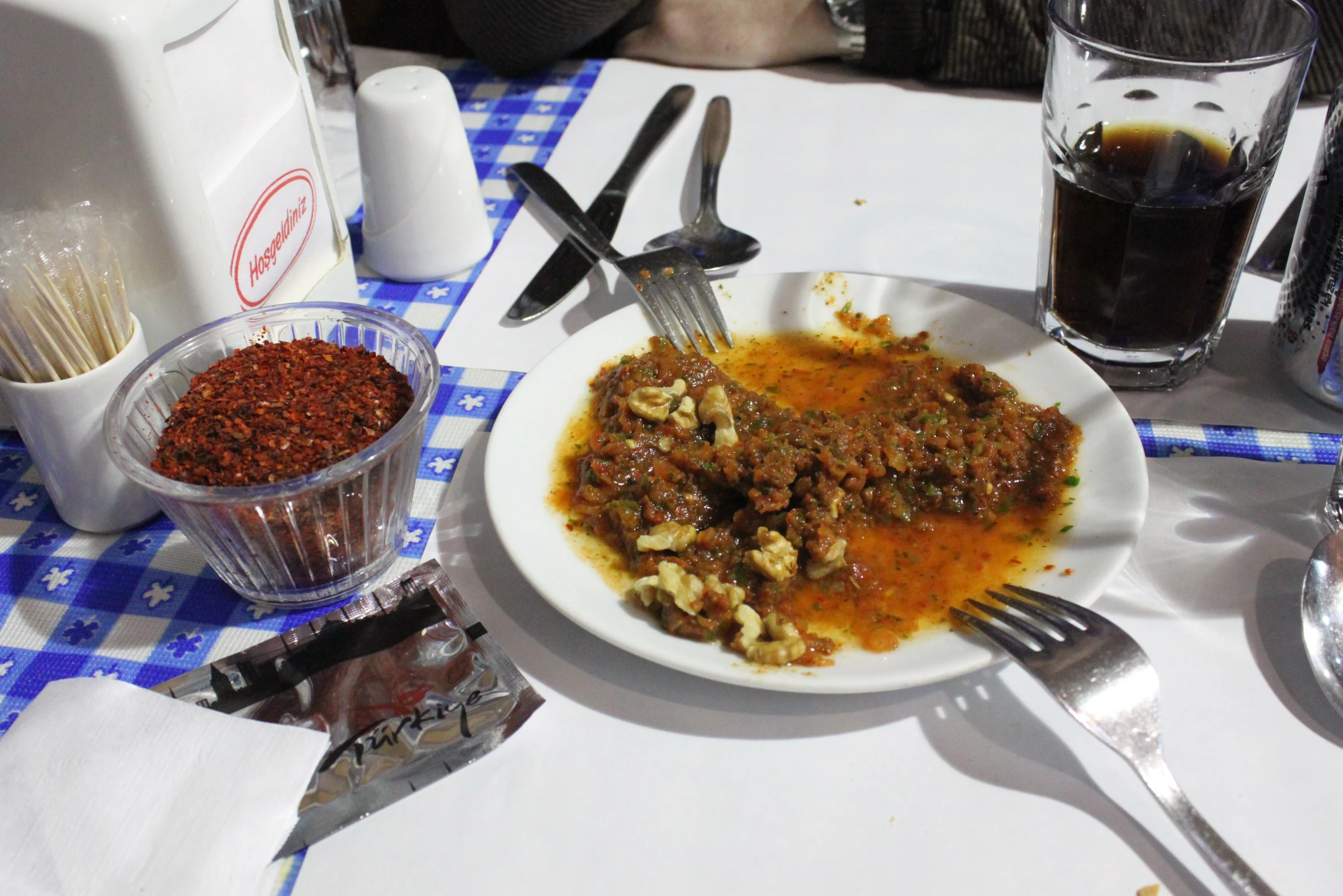 a white plate topped with meat covered in gravy