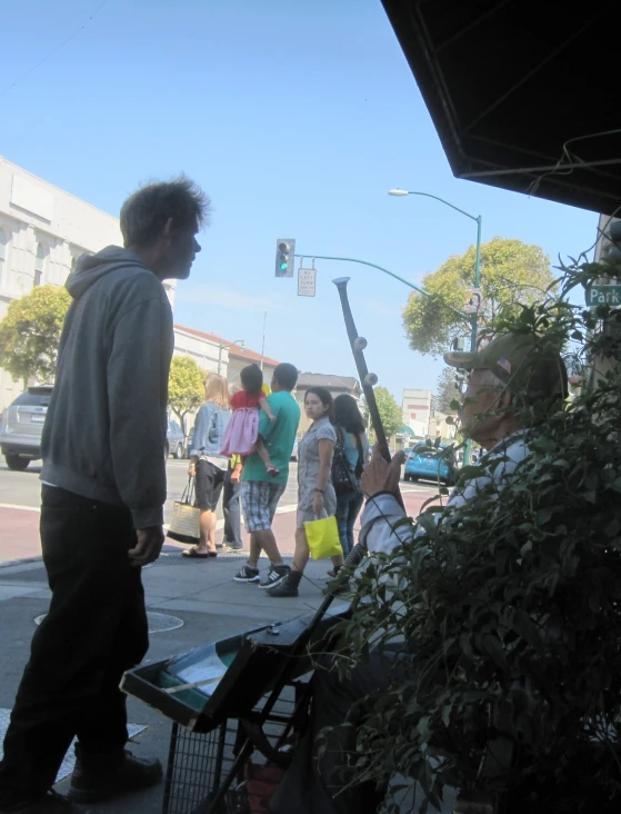 a group of people standing near to a table with food