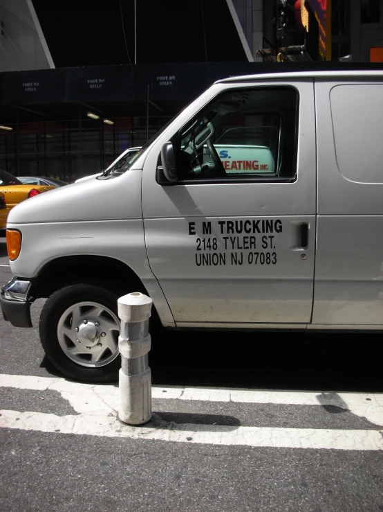 a van with a warning sticker is parked on the street