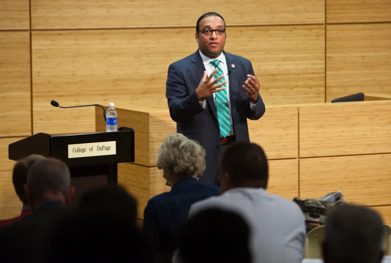 a man speaking in front of an audience