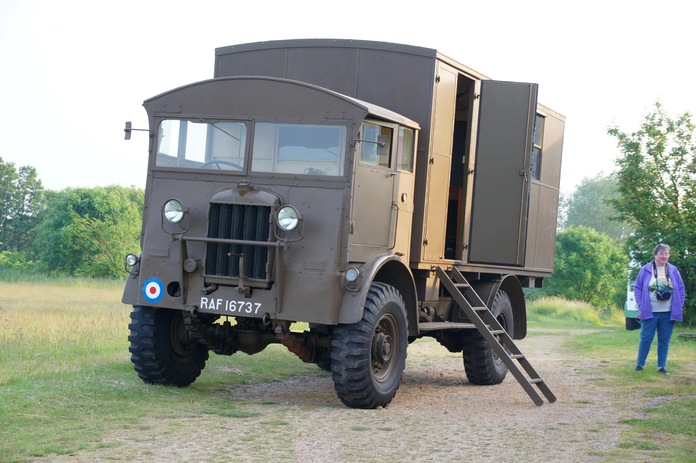 an army truck parked on top of a grass covered field