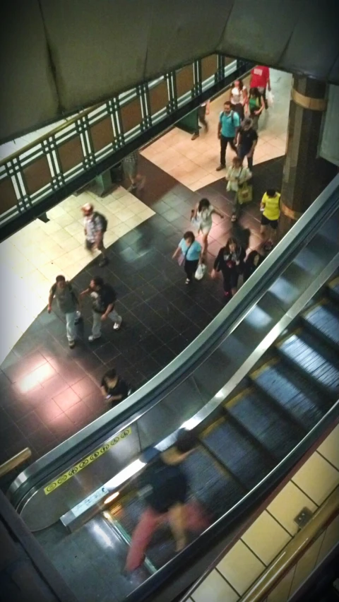 some people riding the escalator at a city station