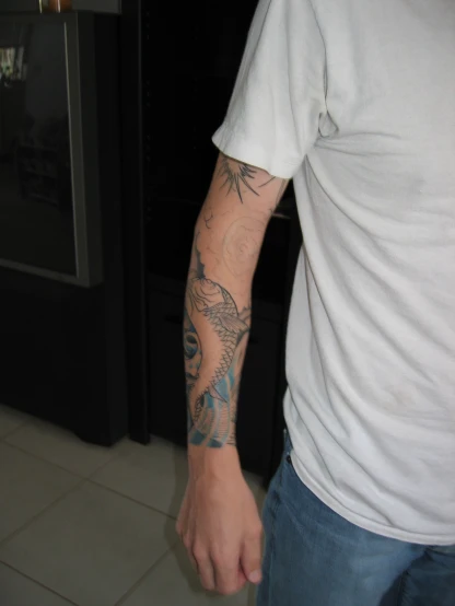 a person wearing a white shirt with a tattoo