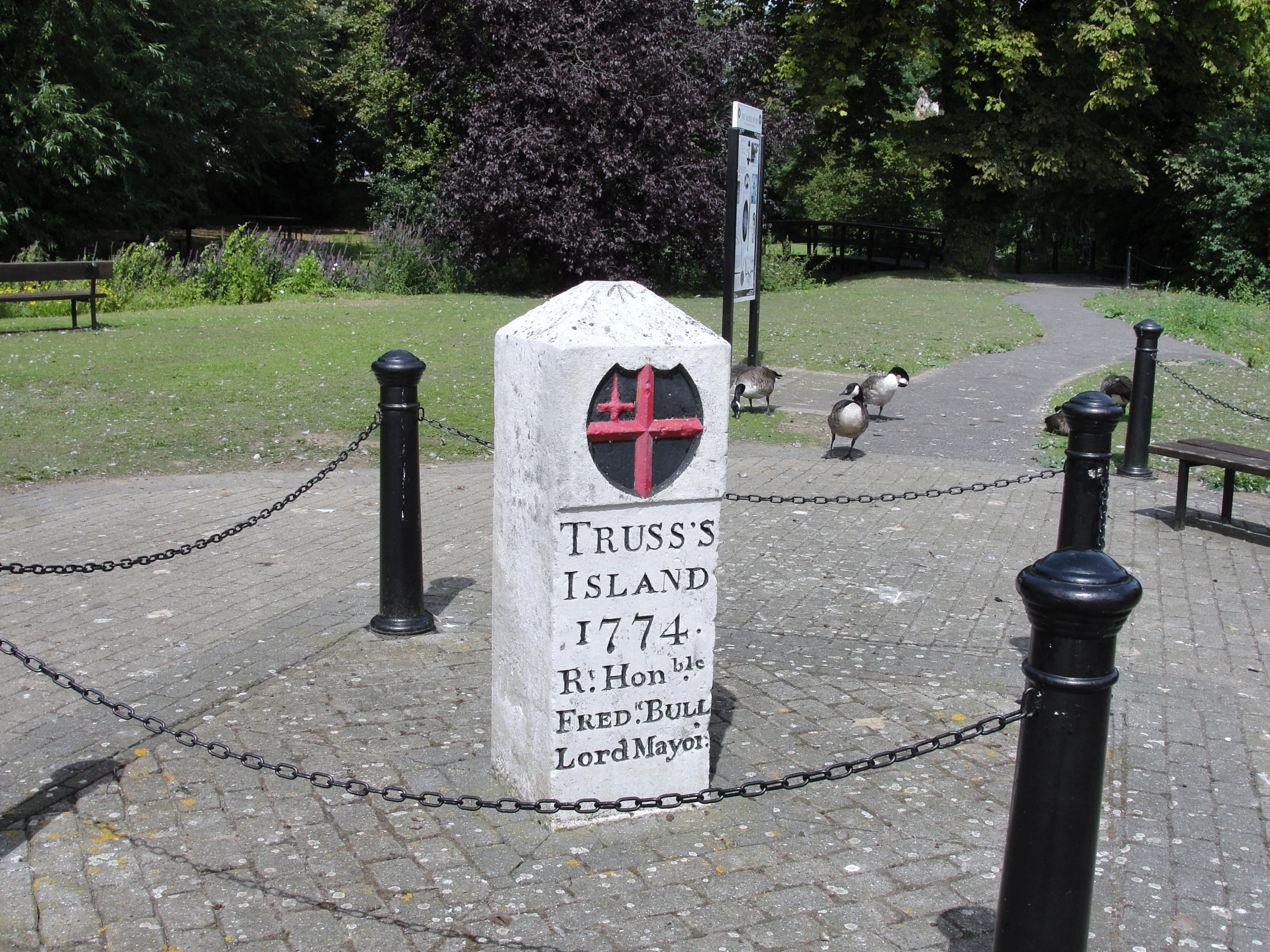 a cross at the entrance to the cemetery