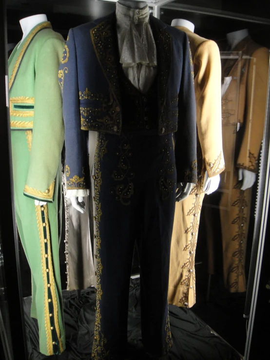 a collection of suit and tie clothing displayed