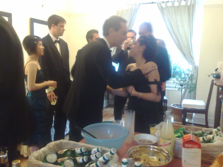 two people in tuxedo are at an event