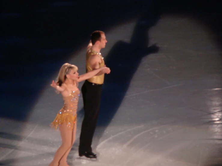 a man and woman perform an ice dance