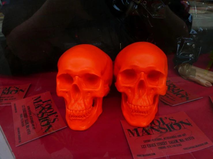 a pair of skulls sitting on top of red sheets