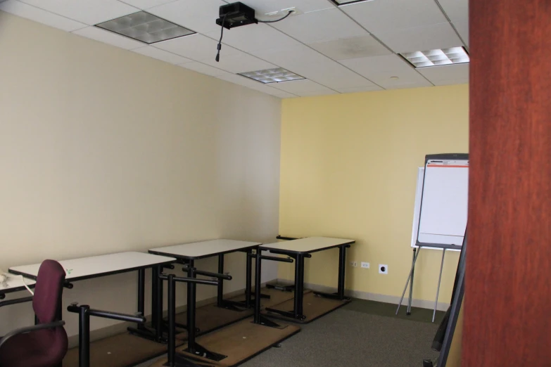 a view of a room with tables and whiteboards