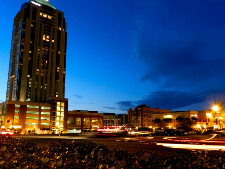 a tall building lit up at night in the evening