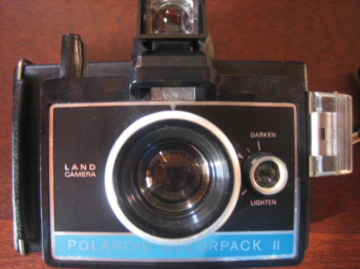 a polaroid camera is displayed with its lens pointed back