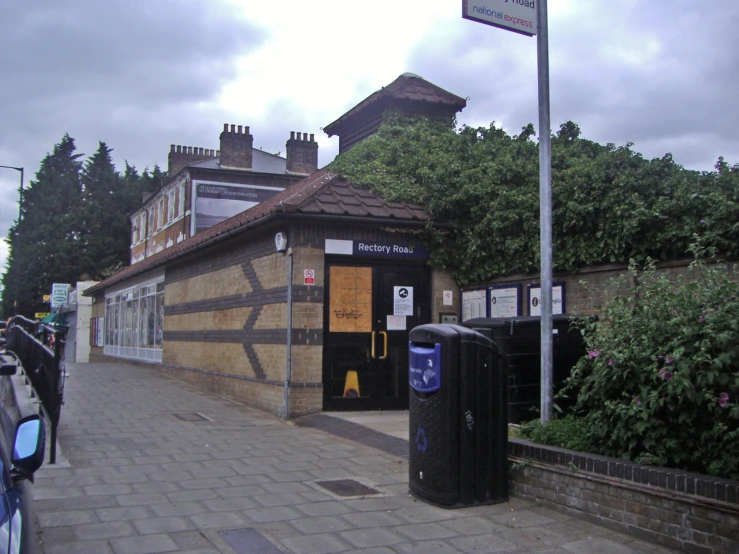 a narrow building has two telephone booths on the outside