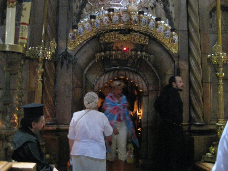 an old po of a man standing at the entrance of a church