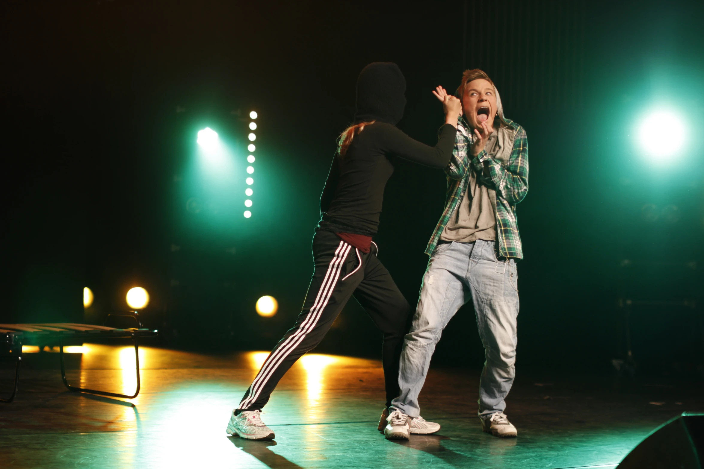 two people are performing onstage on stage