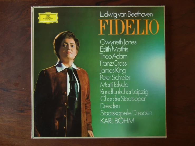 the cover of a cd featuring a man standing in front of a green background