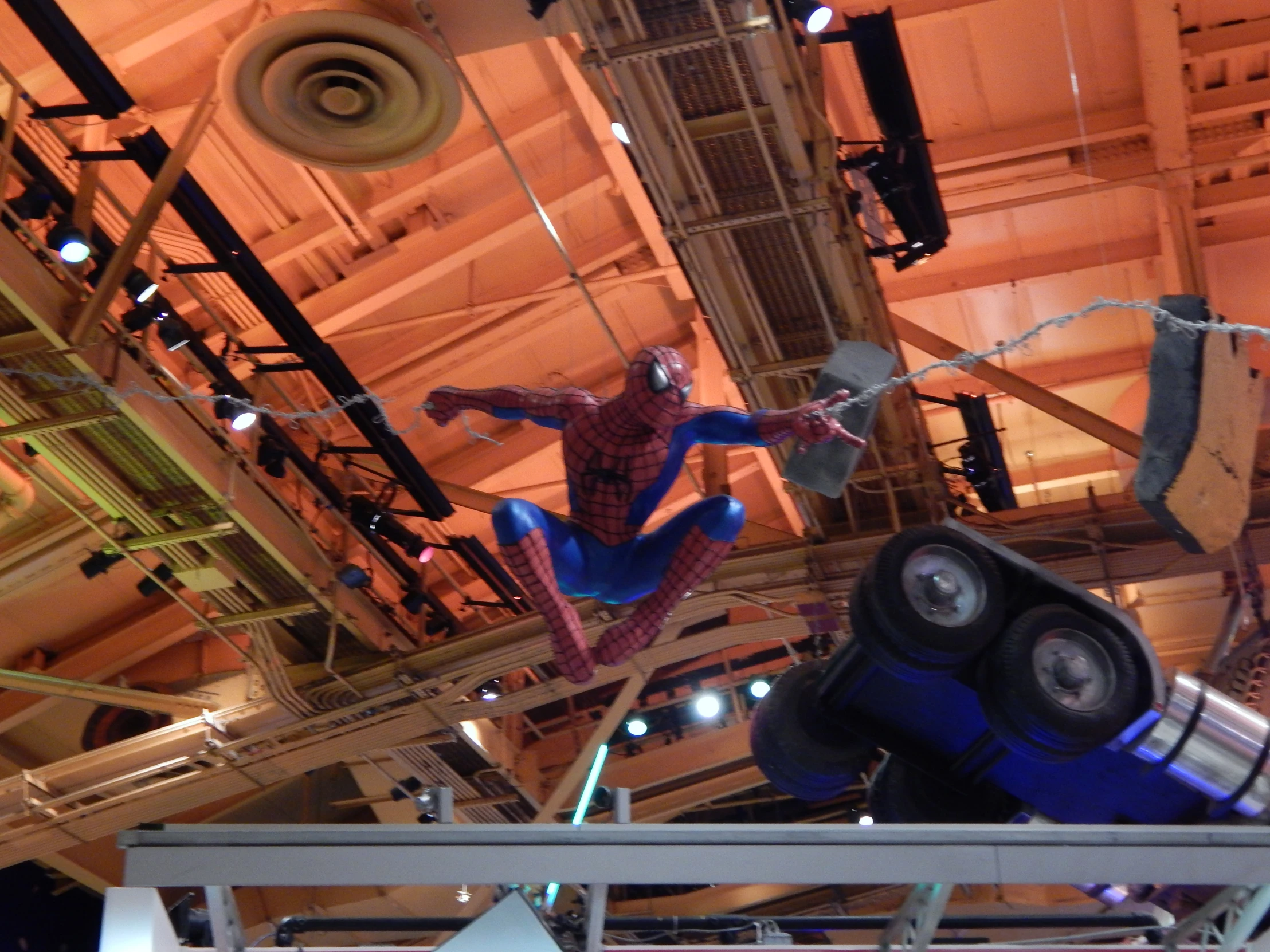 a huge spider man sculpture in the middle of a building