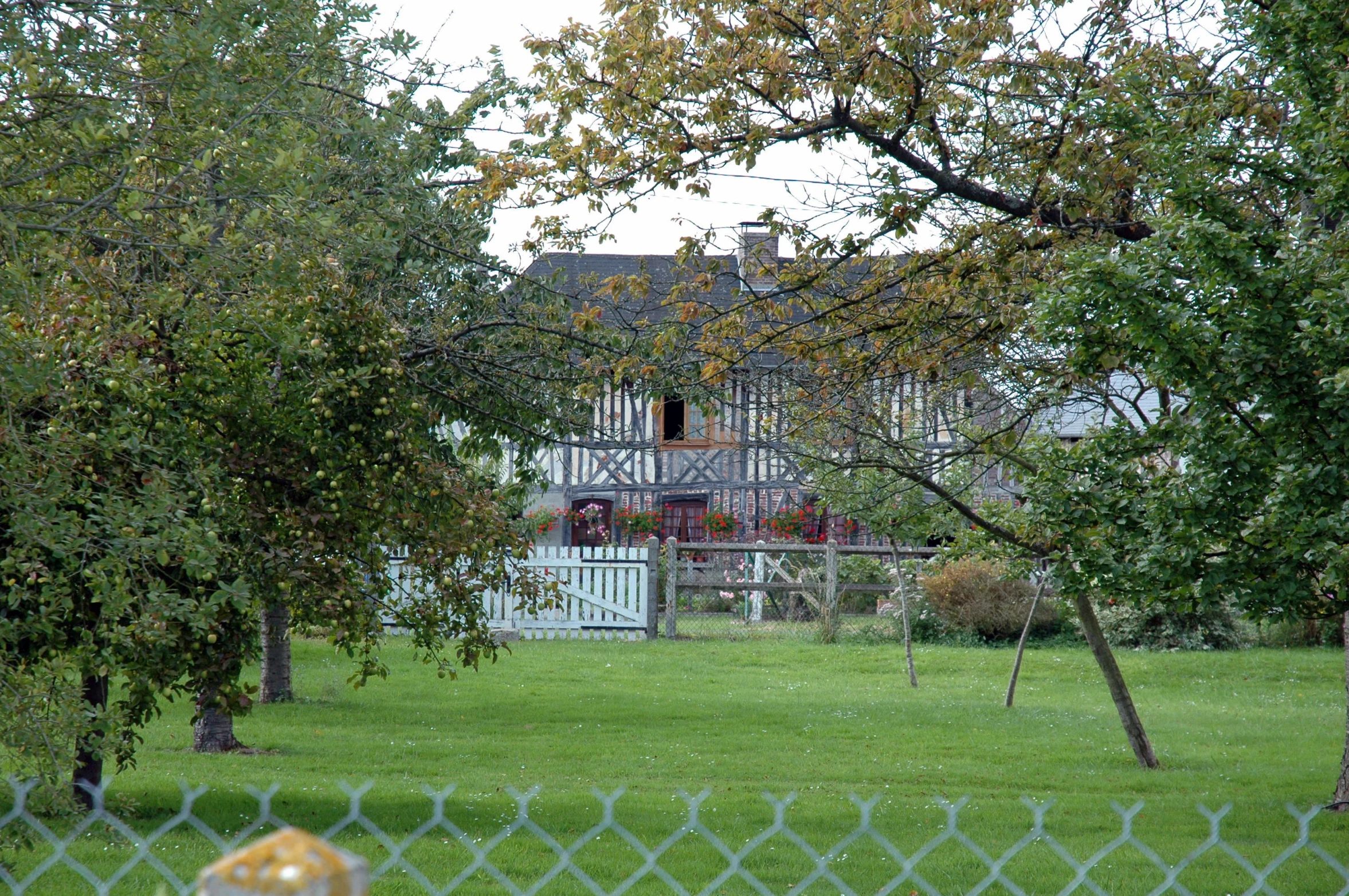 the view from across a large fence of a house in the distance