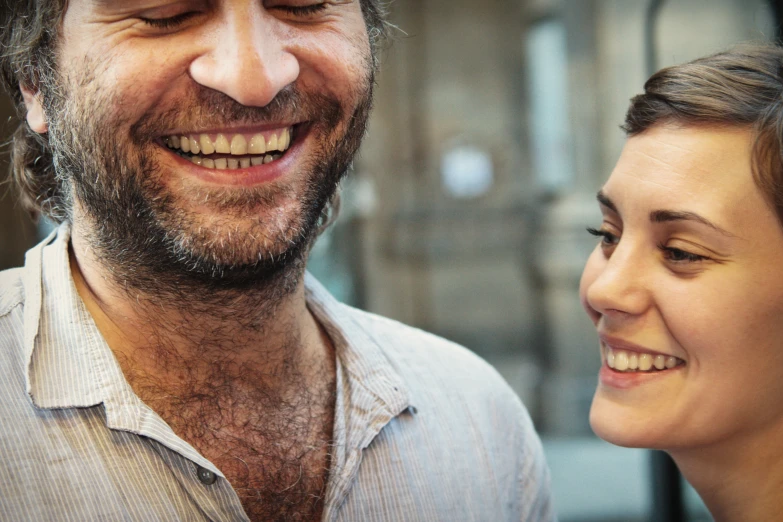 a man looking at a woman while smiling