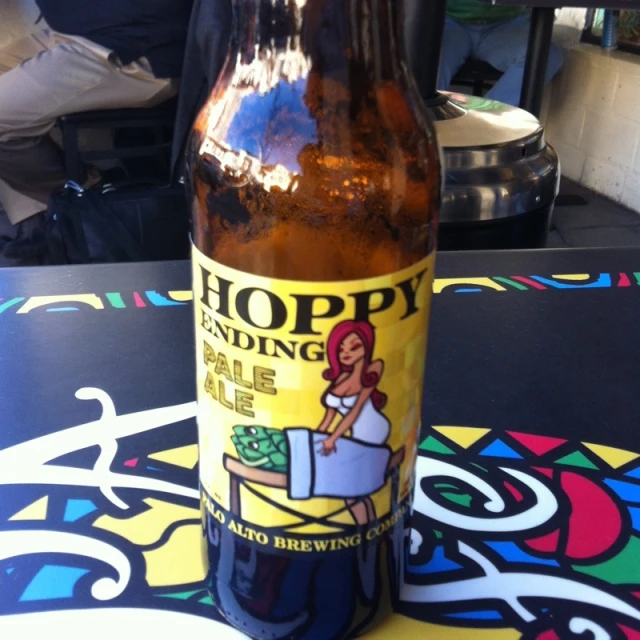 a brown and yellow beer bottle sitting on top of a table