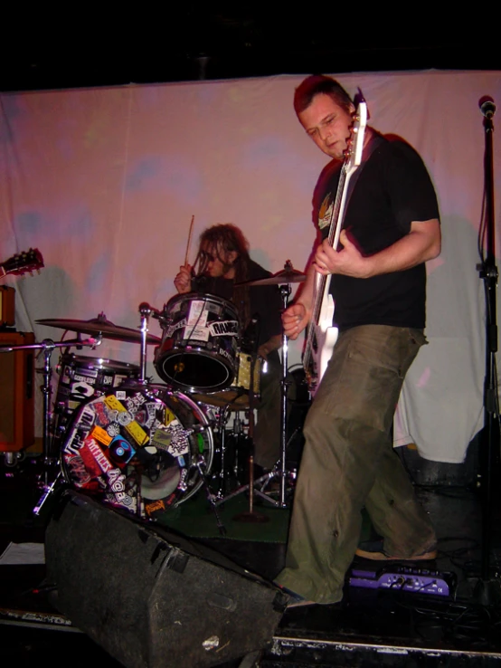 a group of young people playing instruments in front of a crowd