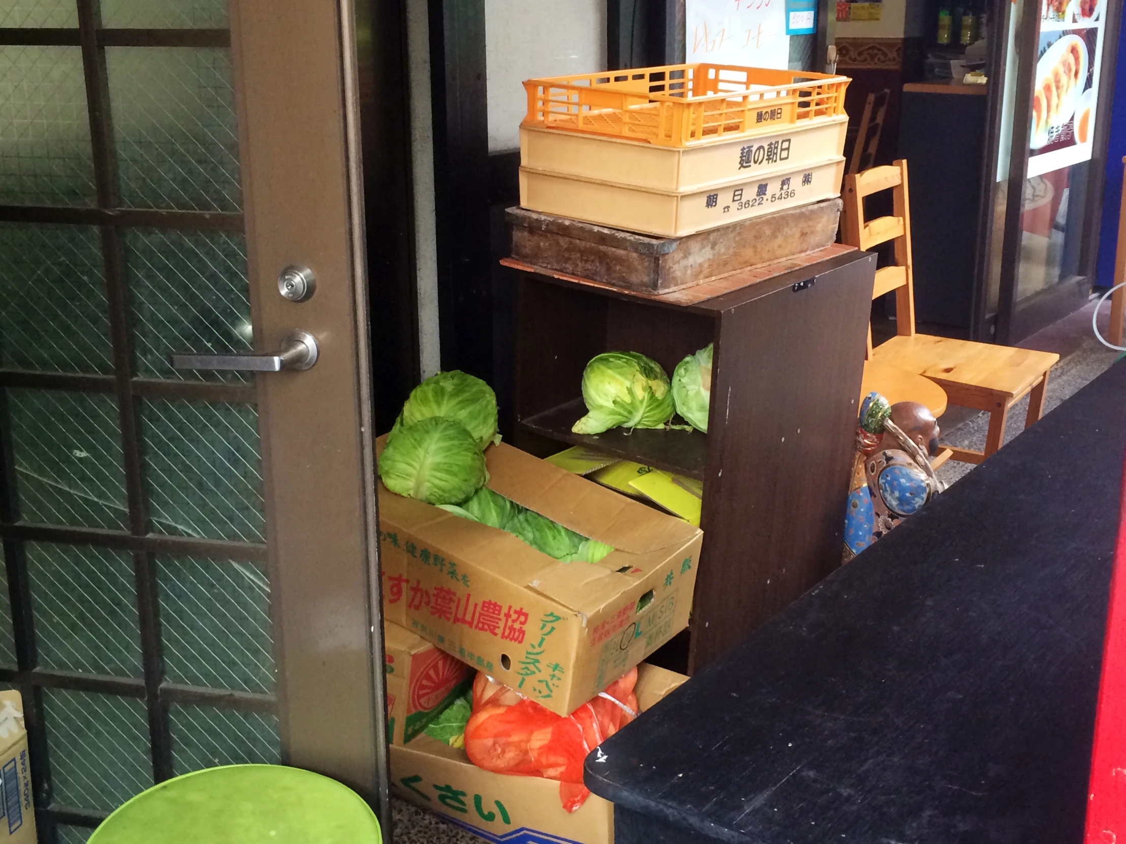 a bunch of boxes stacked high by a doorway