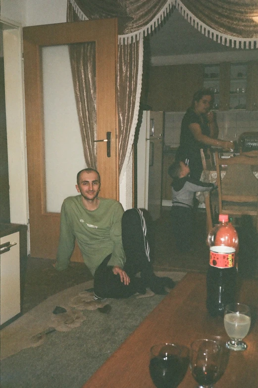 two people sitting on the floor in the living room