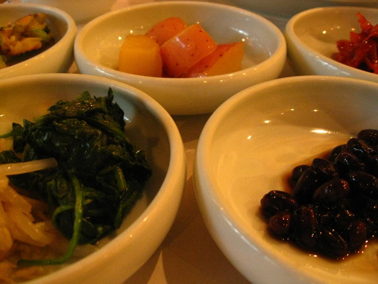 a variety of foods sit in different bowls